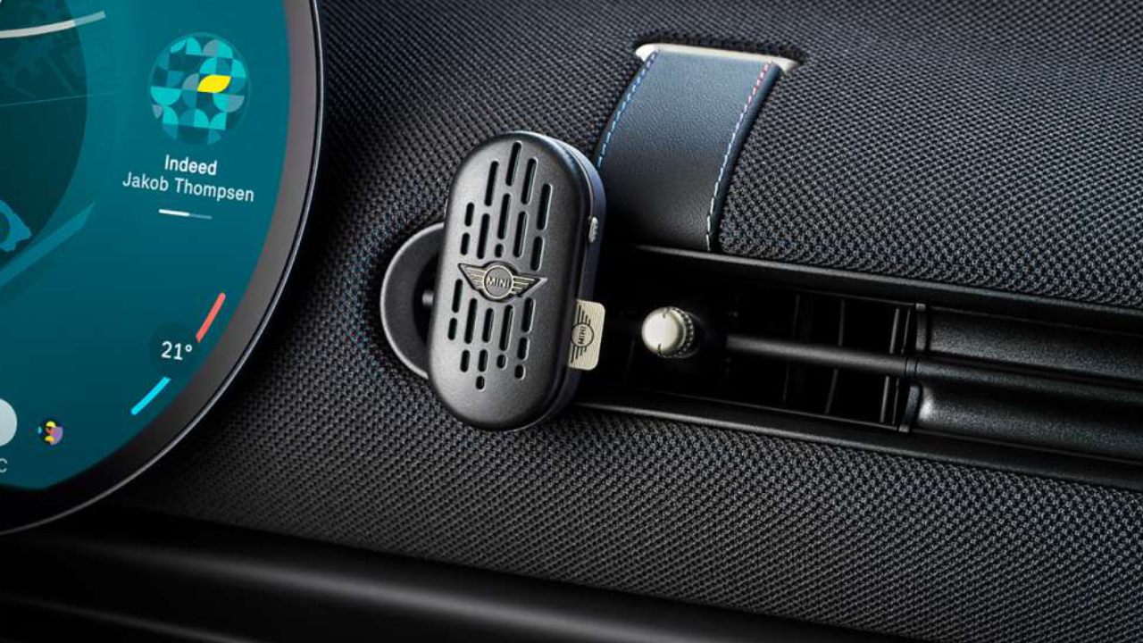 A MINI Natural Air Stick holder clipped to the dashboard of a MINI.