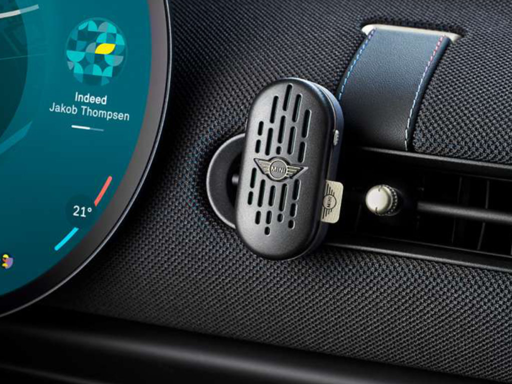 A MINI Natural Air Stick holder clipped to the dashboard of a MINI.