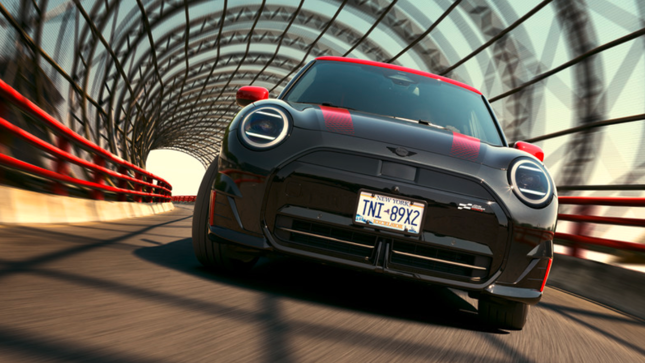 A MINI JCW drives over a gated bridge that looks like a tunnel.
