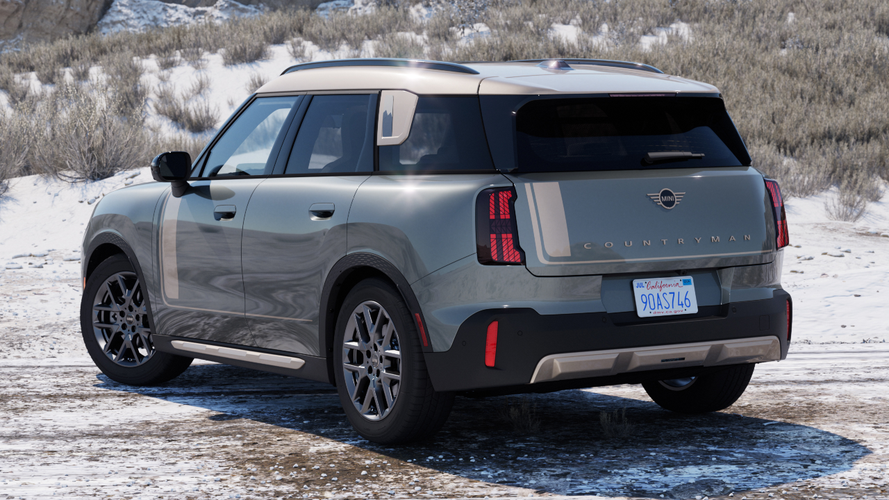 A back angled view of a MINI Countryman sitting in front of a snowy hillside.